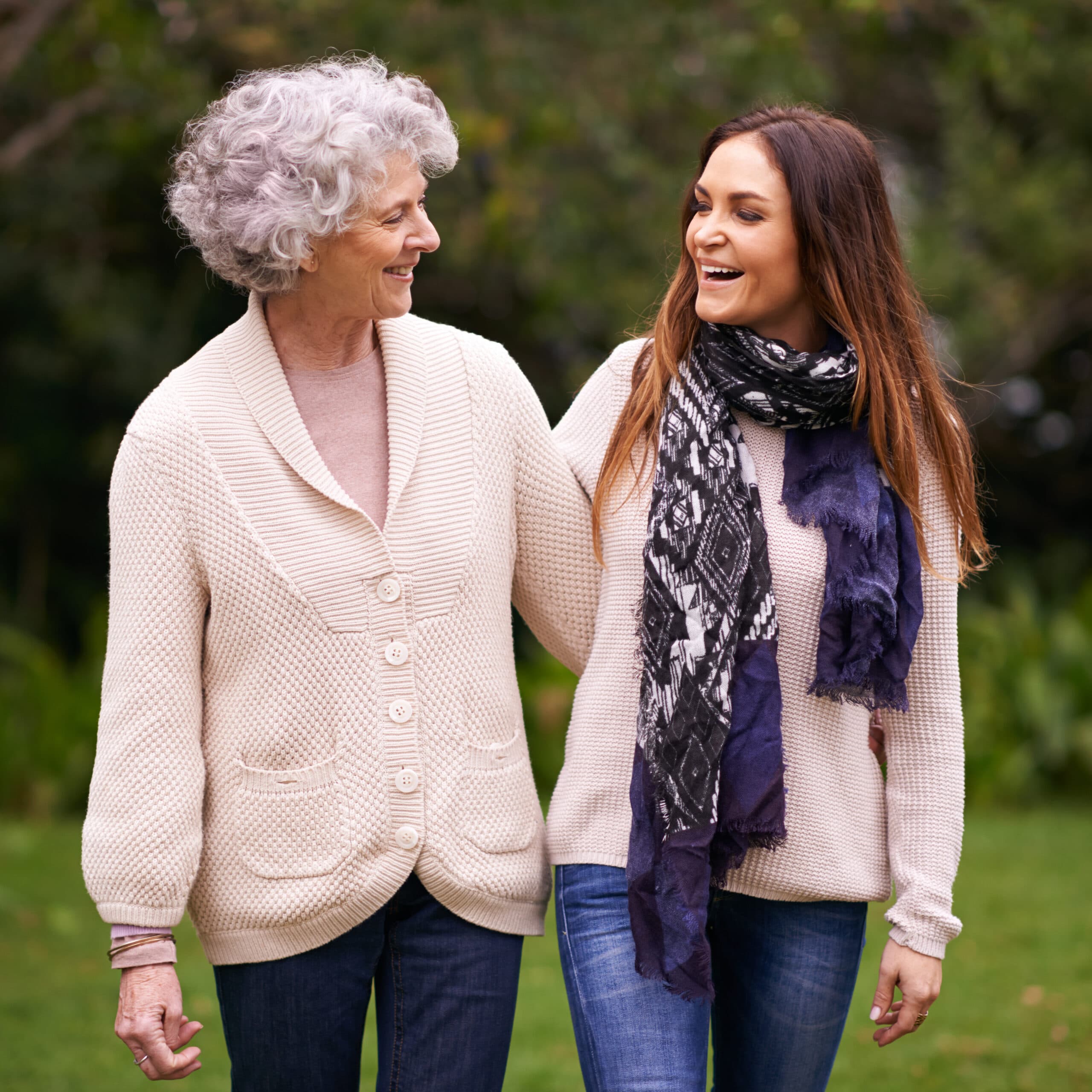 An older woman and a younger woman walking together outdoors