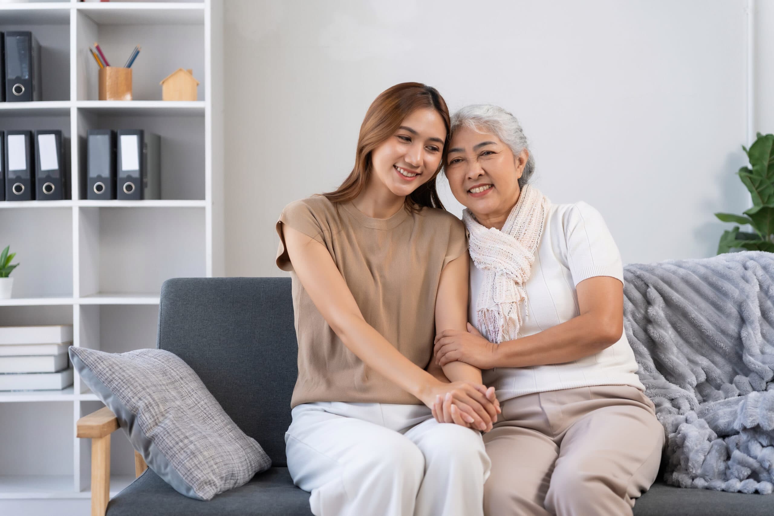A younger woman and an older woman sitting together on a sofa