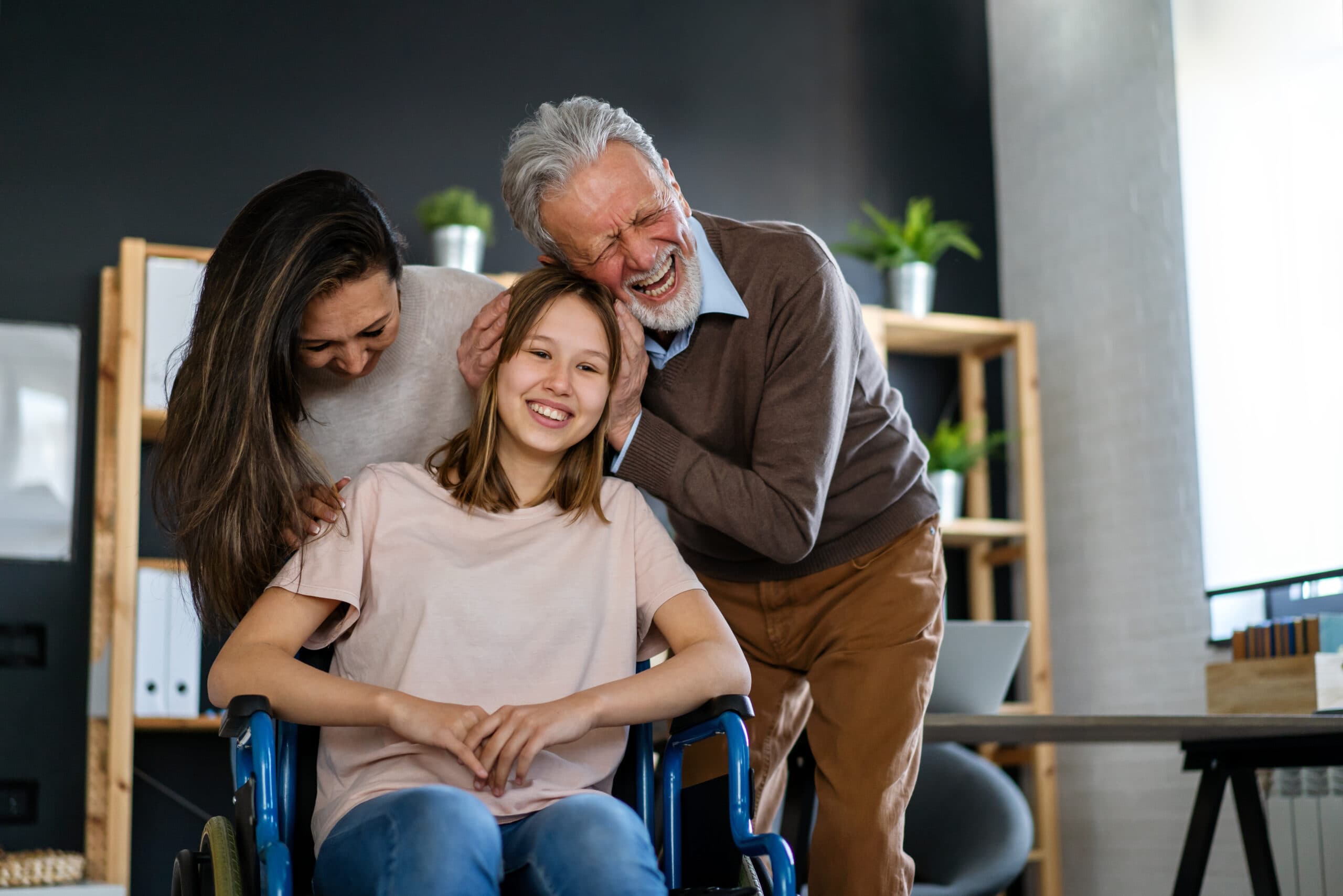 A family gathered around a young woman in a wheelchair